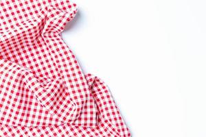 Top view napkin checkers red and white on a white background. Fabric crumpled red and white Isolated with copy space. photo