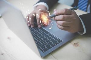 Businessman using a laptop to document management system. Management of documentation online, and digital file storage system or software. photo