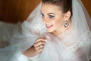 Close-up portrait of a young beautiful bride. Taken from the top view. photo