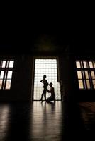 Silhouette of future parents against the window. photo