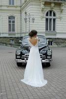 wedding couple with wedding car photo