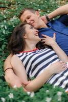 Young beautiful couple in love in the forest. A couple is hugging near a ravine among the trees. Free space. photo