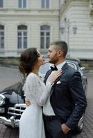 the groom in a gray suit and the bride in a gray dress look at each other, closeup portrait photo