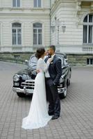 the groom in a gray suit and the bride in a gray dress look at each other, closeup portrait photo