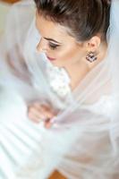 Close-up portrait of a young beautiful bride. Taken from the top view. photo