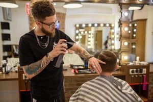 20.02.2020 ucrania, lviv. un peluquero está peinando a un hombre de negocios en una barbería foto