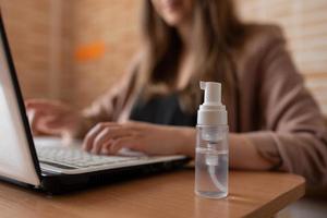 Hand Sanitizers stands near the freelancer workplace. photo