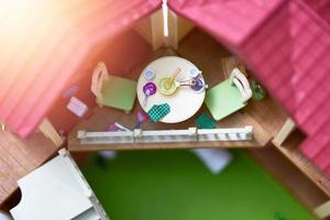 cooking stuffs toy on table in veranda of doll house photo