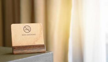 non-Smoking sign or symbol label card holder on corner of table photo