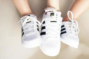 Bangkok ,Thailand,July 18 ,2018-Three white sneaker shoes brand Adidas photo