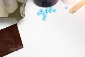 Medical background with blue tablets on drugstore table counter with copy space photo