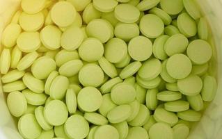 green round tablets in white jar in medical healthcare drugstore concept,closed up photo