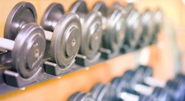 dumbbells set in gym with selective focus photo