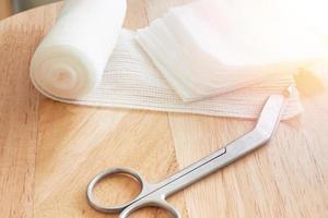 Dressing or clean wound tools includes Roll gauze,pile of gauzes and gauze roll cutter or scissors photo