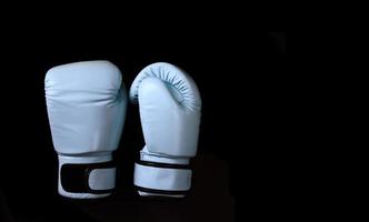 Boxing adhesive gloves on black background photo