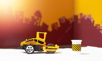Road roller toy ,side view,on blur city background photo