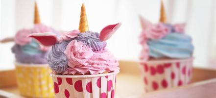 Colorful cupcakes on blur background photo