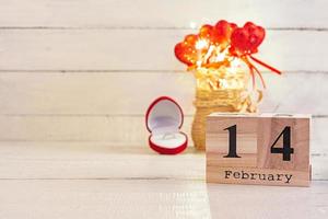 Valentine day. Wooden calendar with February 14 on it. photo