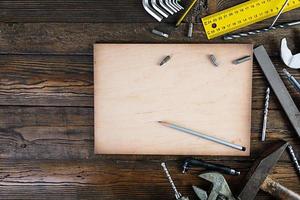 Set of working tools on wooden rustic background. Top view. Copy space photo