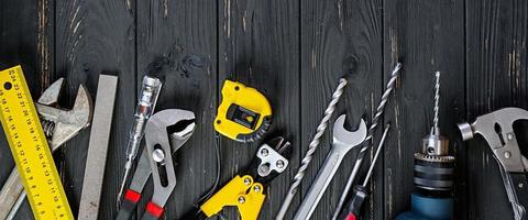 Set of working tools on wooden rustic background. Top view. Copy space photo