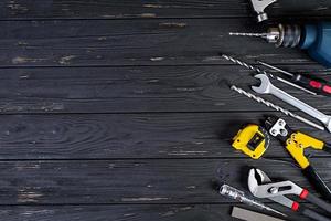 Set of working tools on wooden rustic background. Top view. Copy space photo