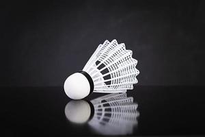 Shuttlecock for badminton isolated on dark background photo