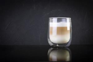 Cup of coffee macchiato. Hot drink coffee on dark background photo