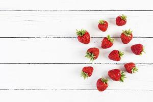 Sweet fresh ripe strawberry isolated on white wooden background. photo