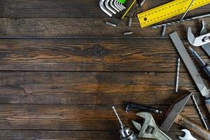 Set of working tools on wooden rustic background. Top view. Copy space photo