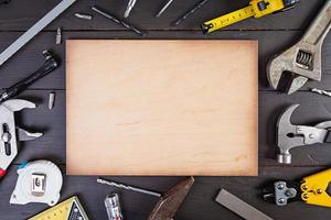 Set of working tools on wooden rustic background. Top view. Copy space photo