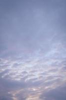 Vertical image of sunset clouds with blue sky in the evening. photo