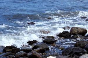 Beautiful romantic photo, seashore on the beach. Relaxing seascape. Waves with foam on the sea. Summer sunny day. Vacation spirit. Beautiful landscape. Nature background photo