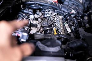 Engine car service mechanic maintenance inspection service maintenance car Check engine oil level car in garage showroom dealership blurred background. photo