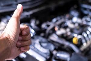 Engine car service mechanic maintenance inspection service maintenance car Check engine oil level car in garage showroom dealership blurred background. photo