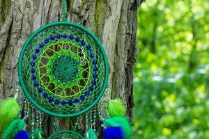 Handmade dream catcher with feathers threads and beads rope hanging photo