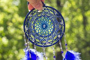 Handmade dream catcher with feathers threads and beads rope hanging photo