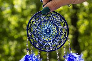 Handmade dream catcher with feathers threads and beads rope hanging photo