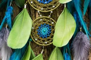 Handmade dream catcher with feathers threads and beads rope hanging photo