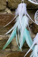 Handmade dream catcher with feathers threads and beads rope hanging photo