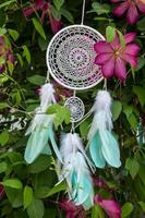 Handmade dream catcher with feathers threads and beads rope hanging photo