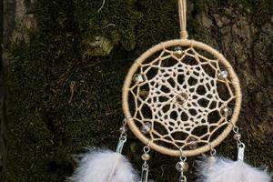 Handmade dream catcher with feathers threads and beads rope hanging photo