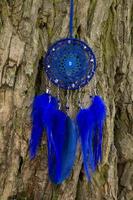 Handmade dream catcher with feathers threads and beads rope hanging photo