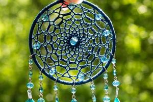 Handmade dream catcher with feathers threads and beads rope hanging photo