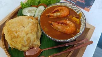 Sour soup with prawn mixed vegetables made of tamarind paste and omelet,cooked rice,Delicious typical Thai food style popular