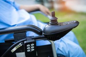 Asian senior or elderly old lady woman patient on electric wheelchair with remote control at nursing hospital ward, healthy strong medical concept photo