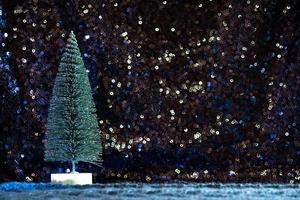 mini Christmas tree on sequin and knit background photo