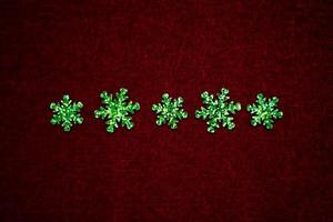 line of green snowflakes on red velvet photo