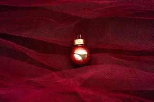 gold ball ornament on red tulle photo