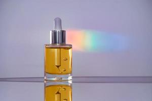 Face oil on reflective surface with a rainbow streak photo