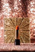 red lipstick on sequin and starburst background photo